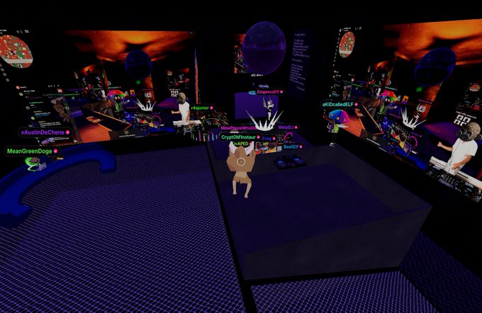 A screenshot from a virtual reality social platform (VRChat-style) showing avatars with usernames like EmperorFF, Aquatic, and MeanGreenDoge in a club-like environment with a DJ booth and large screens.