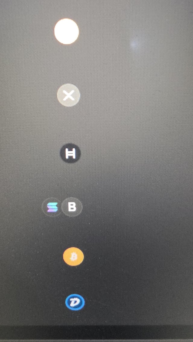 The image shows a vertical column of cryptocurrency token icons on a dark background, including what appears to be X, H, B, another B (Bitcoin), and D (dUSDC). It illustrates a "Hide hidden tokens" feature, likely a setting to conceal or filter out certain less visible or undesirable tokens from view.