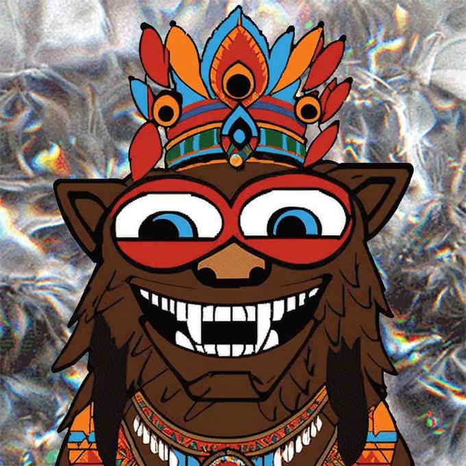 A cartoon illustration of a furry brown creature wearing a red superhero mask and a colorful feathered headdress with geometric patterns, set against a crystalline background.