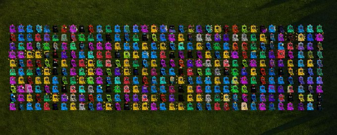 A neatly arranged grid of colorful pixel-art robot figures displayed on grass, likely representing prize entries or participants for the "10x GTD Giveaway" promotion. The image visually showcases the giveaway's reward pool in a vibrant, eye-catching format to attract engagement with the required follow, like, and retweet actions.