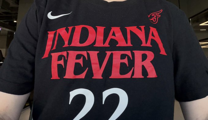 A person wearing a black 'INDIANA FEVER' Nike t-shirt with the number 22 in red and white lettering.