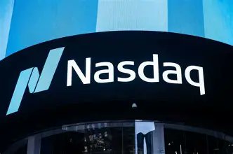 The Nasdaq logo and ticker displayed on a curved blue digital screen.