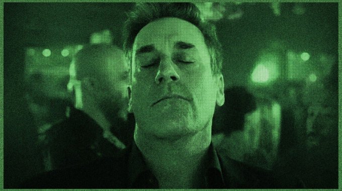 A man with closed eyes appears to be in deep thought or meditation, rendered with a green-tinted, pixelated filter effect against a blurred background of people.