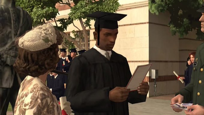 A screenshot from a video game showing a Black male character in a graduation cap and gown reading a diploma at an outdoor graduation ceremony, with other graduates and attendees in the background.
