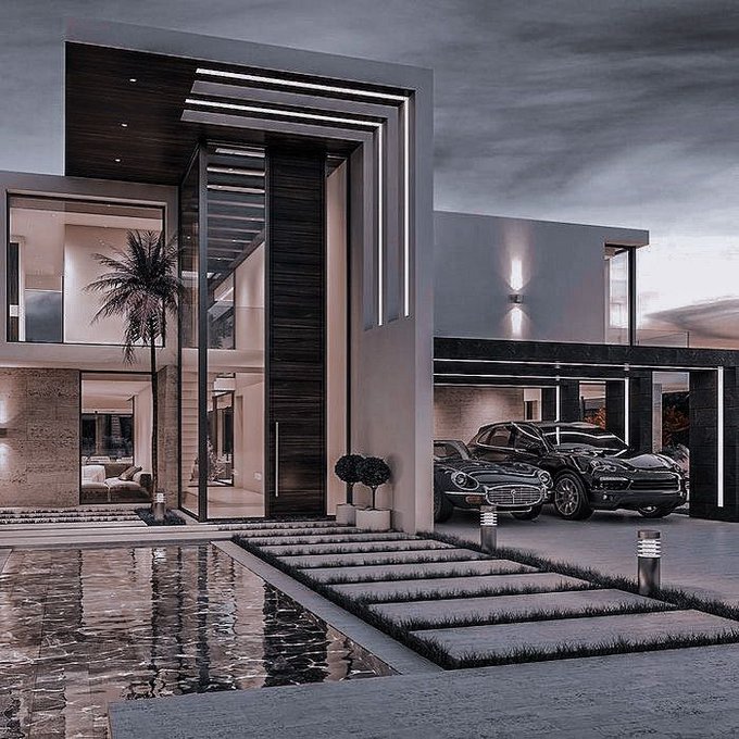 A luxurious modern mansion at dusk features a striking geometric facade with integrated LED lighting, housing a vintage sports car and Porsche in its glass-walled garage beside a reflective pool. The image aligns with the post's theme of "real grinders" by visually representing the pinnacle of success and luxury lifestyle that participants might aspire to through @quipnetwork.
