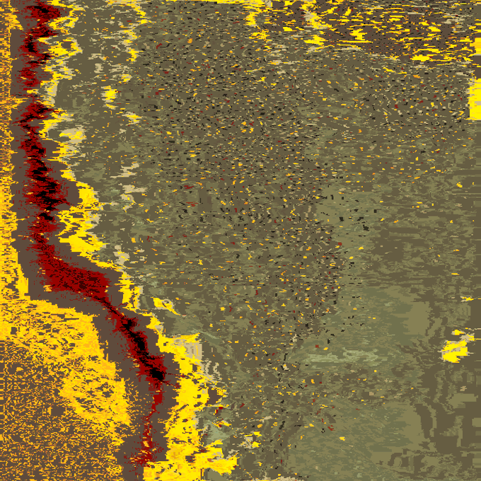 The image features a close-up view of a wall with a unique texture, resembling sand or dirt. The wall has a brownish hue that gives it an earthy appearance. There are numerous small specks scattered across the surface, adding depth and dimension to the scene. The image is described as being blurry, which further emphasizes the texture and graininess of the wall.