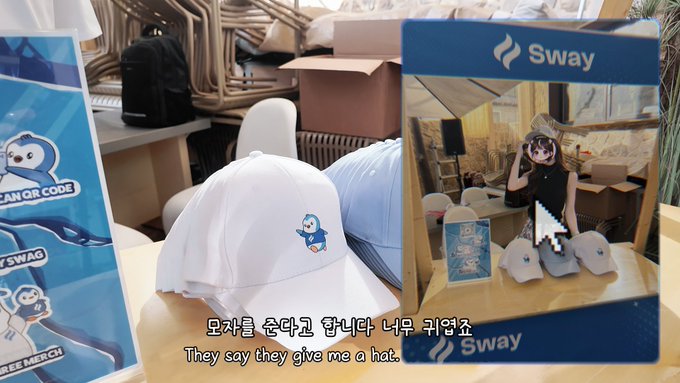 A video still shows merchandise including white hats with a polar bear logo and QR codes, alongside a "Sway" branded display; Korean text and the English subtitle "They say they give me a hat" appear at the bottom.