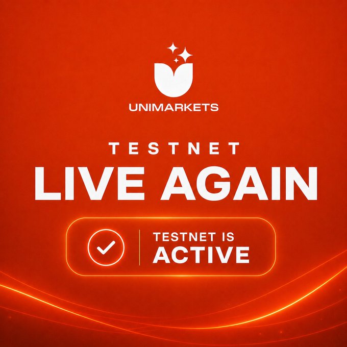 A bold red promotional graphic for UniMarkets announces the return of their testnet, featuring the company's white tulip-like logo and a checkmark badge reading "TESTNET IS ACTIVE" beneath the headline "TESTNET LIVE AGAIN."

The image visually reinforces the post's message that maintenance is complete and the UniMarkets Testnet is back online, allowing users to resume trading and earning XP.