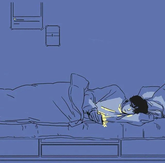 A person lies on a bed in a blue-hued room, illuminated only by the warm glow of their phone screen, with a notification visible on their phone. The post reads "Goodnight," suggesting someone choosing to stay up late on their device rather than sleep.