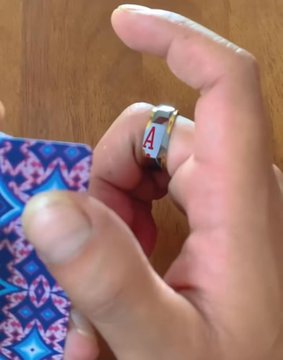A hand is shown wearing a small white ring on its finger, with the number "4" displayed in red on the ring. The image relates to the post by giving the impression of an extra finger, matching the playful "9-finger version" upgrade joke.