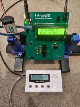 An electronic testing device labeled 'Entropy32 The Entropy Estimator' with an LCD screen displaying 'LRB 0 CPR 18' and 'Bits 45-912', connected to various components.