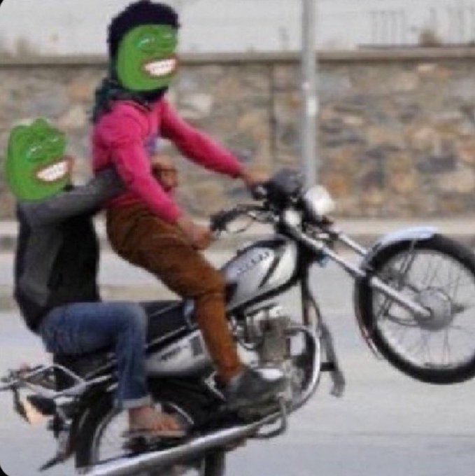 A meme image showing two people doing a wheelie on a motorcycle, with their faces obscured by grinning Pepe the Frog masks.