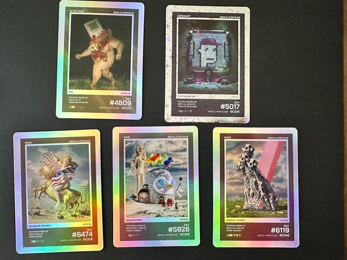 The image shows a collection of five different Opened My First pack of @beeple cards, each featuring unique artwork or designs. The cards are displayed against a black background, making them stand out prominently. The text "Opened my first pack of @beeple cards" is visible in the image, indicating that this is an advertisement for these cards and their contents.