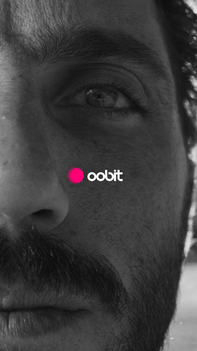 A black-and-white extreme close-up of a bearded man's face, focusing on his eye and textured skin, overlaid with a pink dot logo and the text 'oobit'.