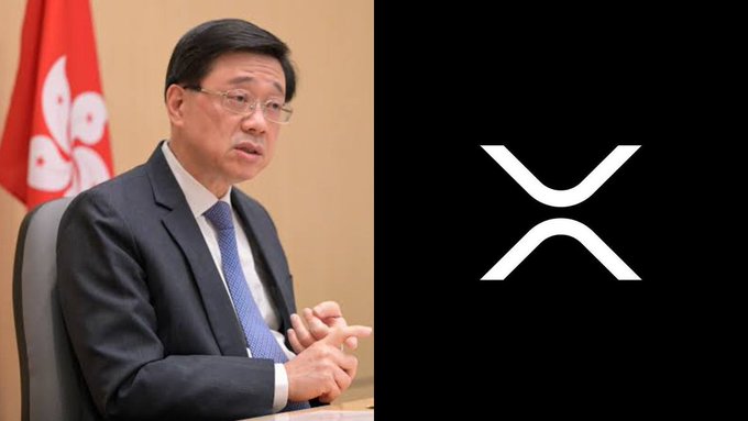A man in a suit sits in front of the Hong Kong flag next to the XRP logo, visually representing Hong Kong's opening of access to XRP for retail investors.