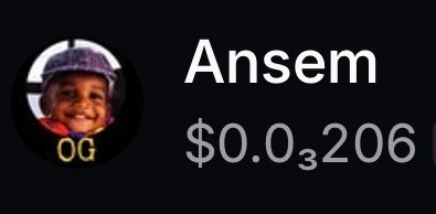 A digital display showing a profile with the name 'Ansem', a profile picture of a smiling child wearing a cap with 'OG' text, and a balance of '$0.03206'.