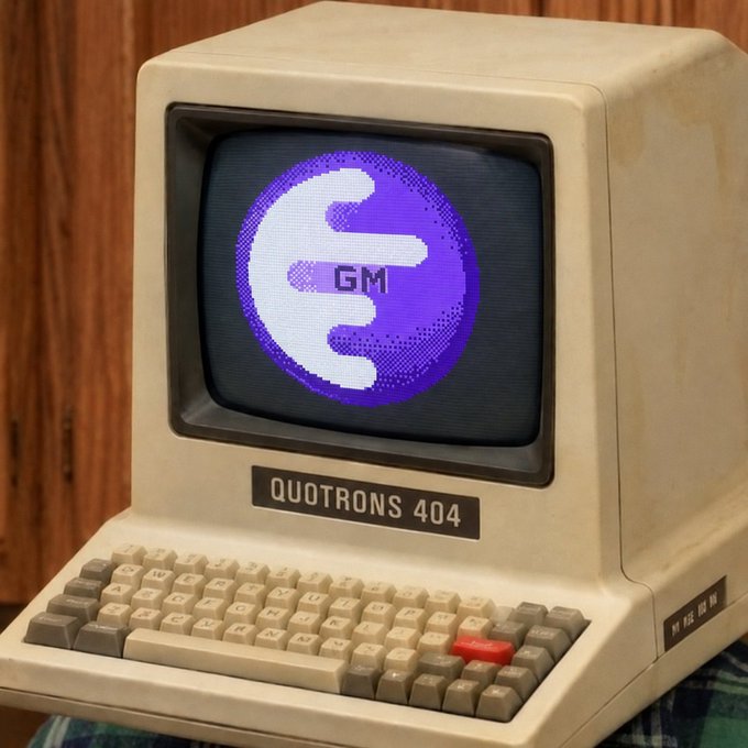 A vintage beige Quotrens 404 computer terminal with a CRT monitor displaying a purple pixelated "GM" logo.