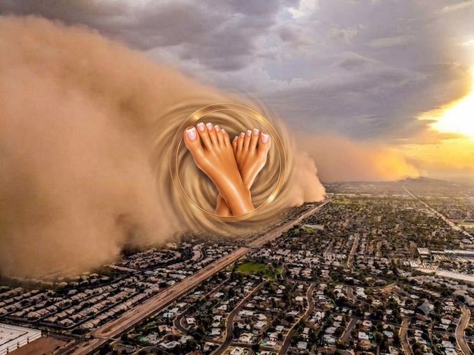 An aerial view of a massive dust storm approaching a suburban neighborhood, with a surreal digital overlay of crossed female feet with painted toes in a golden circle.