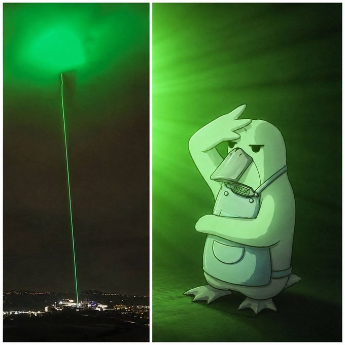 The left panel shows a bright green laser beam piercing the night sky above a cityscape, while the right panel features Psyduck wearing an overall tag reading "102.6F" shielding its eyes against the green glow—together humorously capturing the post's "Who's actually locked in?" by depicting a literal green laser lock-in moment alongside a meme character overwhelmed by it.
