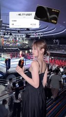 A woman in a dark dress at what appears to be a trading floor or exhibition, with an overlay showing '-46,77 USDT' and a Visa card image in the upper right.