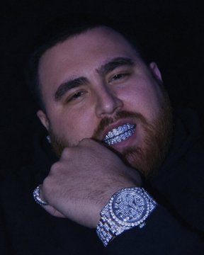 This image shows a man with diamond grills and a diamond-encrusted watch, likely representing the extravagant "7M won on Keno" mentioned in the post. The visible bling suggests a victory that has led to this lavish display.