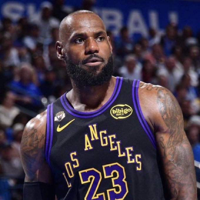 LeBron James, wearing the Los Angeles Lakers' #23 "Los Angeles" City Edition jersey with Bibigo sponsorship, looks focused during a game, while the accompanying post advocates for fully investing in his teammate Luka Dončić as the future face of the franchise.