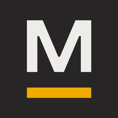 The image displays a stylized "M" logo for MARA on a black background, with a distinctive yellow horizontal bar beneath it. This logo relates to the post as it represents MARA, the Bitcoin mining firm referenced as actively purchasing more Bitcoin ($BTC).