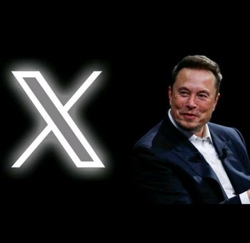 Elon Musk sits in front of the X (formerly Twitter) logo on a black background.
