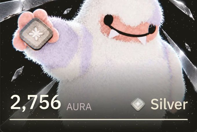 A fluffy white cartoon character with fangs holds up a silver token emblem, with text reading '2,756 AURA Silver'.