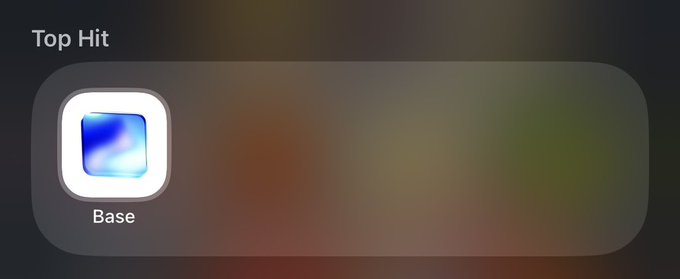 iphone screen displays a dark gray background with a white square app icon and the option to "Base" at the bottom right corner.