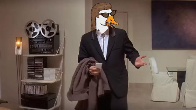 A meme image of a person in a suit with a goose head wearing sunglasses, holding a jacket in an office setting.