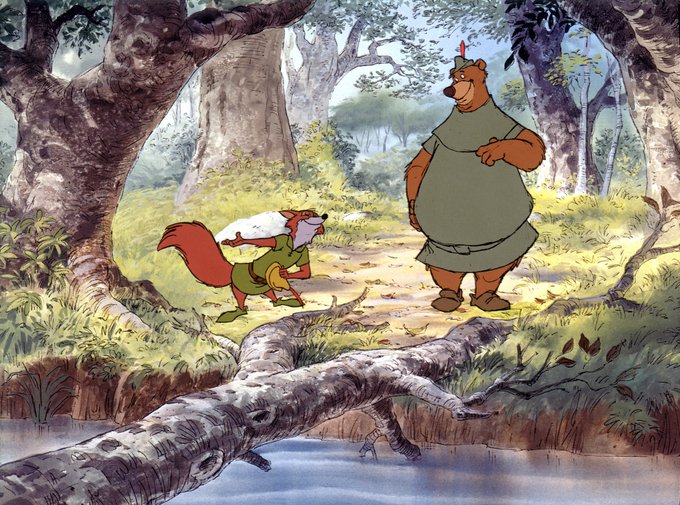 The image shows a scene from Disney's "Robin Hood" featuring Robin Hood (the fox) and Little John (the bear), with Robin Hood holding a yellow chicken (likely referencing his companion Lady Cluck or a captured bird).

The caption cleverly combines the visual with the post's playful claim: "Disney's Robin Hood and Little John sharing a moment in Sherwood Forest—proving the bear was always the fox's ride-or-die best friend, just like the homies in the post remember." 🏹