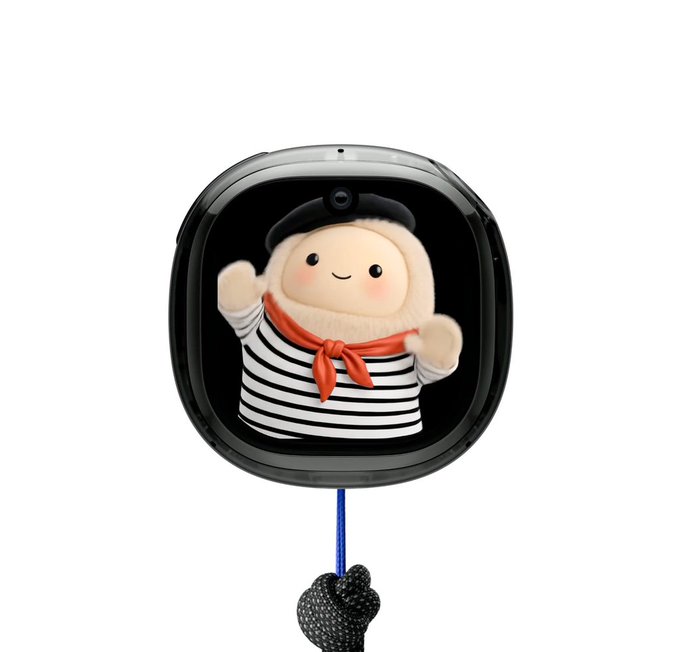 A small, round electronic device with a screen displaying an animated mascot wearing a black beret, striped shirt, and a red neckerchief.