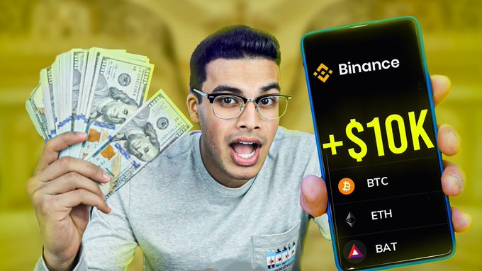 The image shows a man holding up his cell phone, displaying its screen, which has Bitcoin symbols at the top right corner. The text displayed on the phone reads "Binance + $10k", suggesting that he may have just made or is about to make an investment in Bitcoin using his phone. The phrase "while you're sleeping, the market is printing" indicates that this might be happening as a part of an overnight trading strategy, where someone wakes up and sees their investments grow due to overnight market fluctuations.