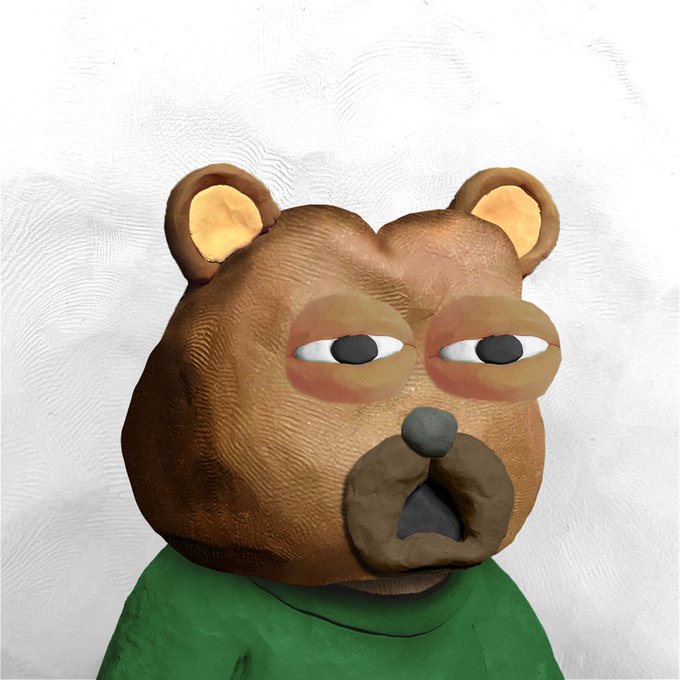 A 3D claymation-style sculpture of a brown bear head with a lazy expression, wearing a green shirt against a white background.