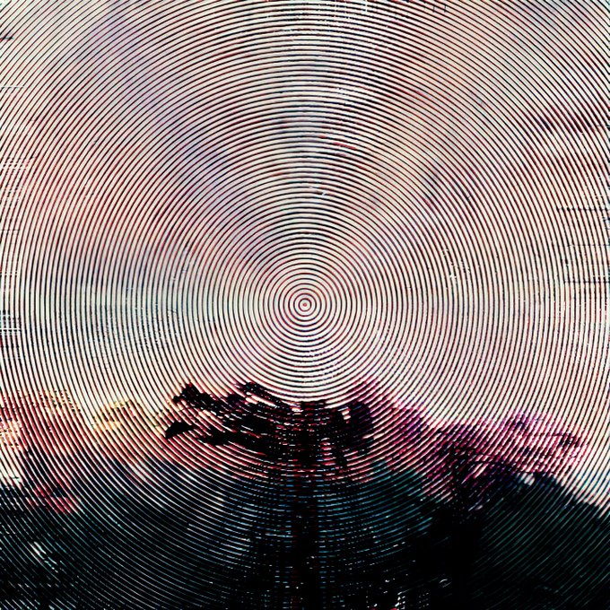 An abstract design displays concentric pink and black circular lines creating a target-like pattern, with a dark, silhouetted landscape visible at the bottom.