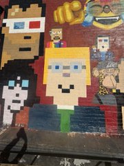 A Minecraft-themed pixel art mural depicts blocky characters including one wearing 3D glasses.