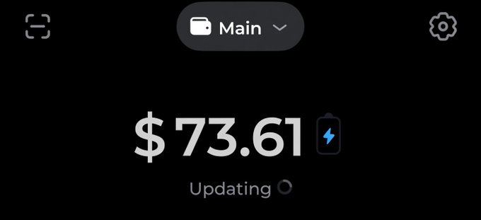 A screenshot displaying a cryptocurrency wallet interface showing a "Main" account balance of $73.61 with a charging/low battery indicator and an "Updating" status message. The image is likely being used to demonstrate the poster's available funds in support of their $70 SOL giveaway announcement.