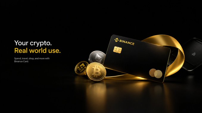 A sleek black Binance Card with gold accents is prominently displayed alongside physical representations of Bitcoin and other cryptocurrencies, with the tagline "Your crypto. Real world use." reinforcing the post's message that the card's true value lies in bridging digital assets with everyday spending utility.