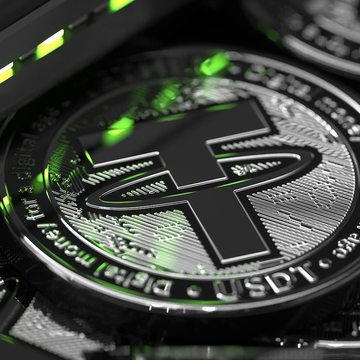 The image shows a close-up view of a coin with the word "USDC" written on it. The coin has a green light shining on it, which makes it stand out against its black background. In the corner of the image, there is text that reads "LATEST: Dragonfly’s Rob Hadick says the USDT-USDC duopoly is unlikely to last, arguing that stablecoins are still in the early stages of development and that new competitors will gain market share through payments, distribution networks, and compliance infrastructure." This text provides context about the coin's value or significance.