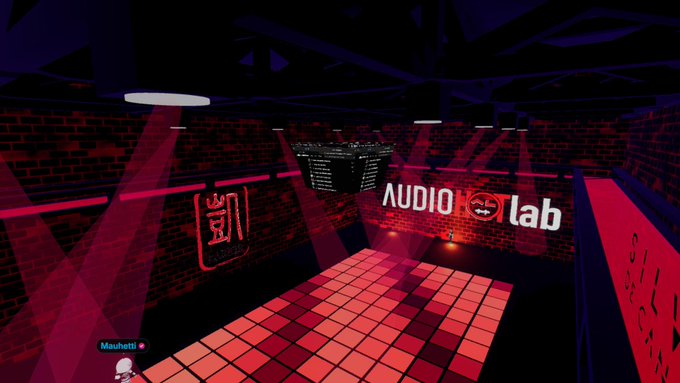 A dark, red-lit virtual room with disco lights featuring an "AUDIO lab" neon sign and a dance floor with a user named Maahetti.