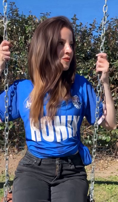 A young woman sits on a swing, wearing a blue "RONIN" jersey while enjoying a sunny day outdoors, tying into the post's mention of the Ronin Network and the pleasant spring-like weather in Buenos Aires.