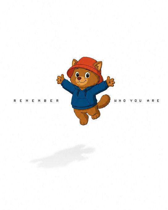 The image features a cartoon cat wearing a red hat and a blue hoodie, jumping into the air with its arms outstretched. The caption below the image reads "Remember who you are". The text is written in black against a white background, making it stand out prominently.