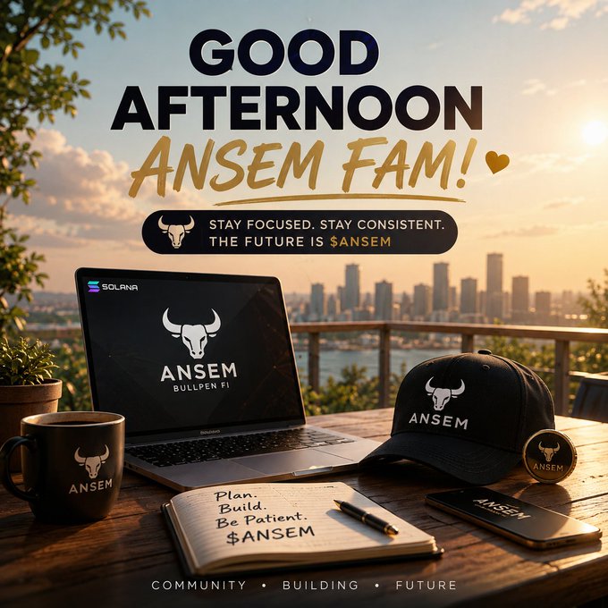 A motivational branded scene featuring ANSEM merchandise (a laptop, cap, mug, and phone) arranged on a wooden desk with a city skyline at sunset, displaying "GOOD AFTERNOON ANSEM FAM!" and the message "STAY FOCUSED. STAY CONSISTENT. THE FUTURE IS $ANSEM." The image visually reinforces the post's theme of patient conviction and community strength by showing the brand ecosystem alongside a journal noting "Plan. Build. Be Patient. $ANSEM," echoing the call for holders to stay committed through market swings.