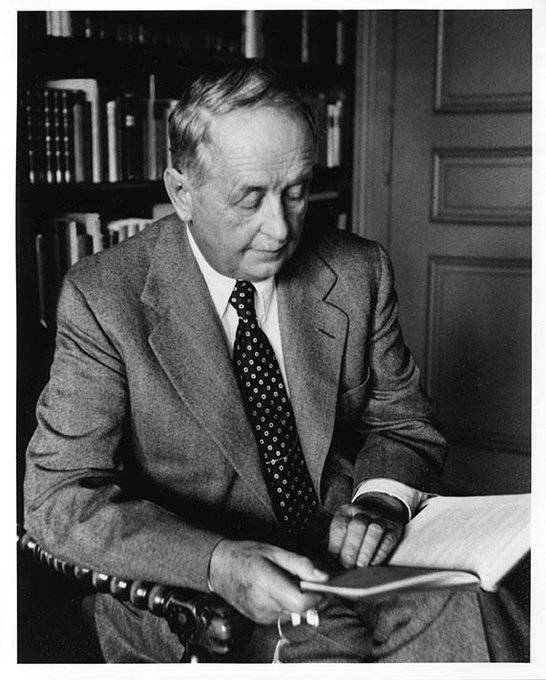 A black-and-white photograph shows an elderly gentleman in a suit and polka-dot tie, seated and reading a large book in what appears to be a library or study with bookshelves visible behind him. The caption suggests a moment of quiet contemplation, fitting with the post's reflection on the depth of the story being shared.
