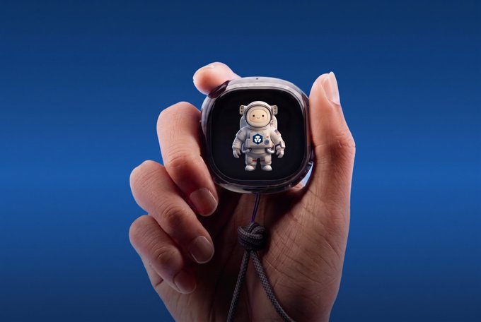 A hand holding a smartwatch displaying a 3D astronaut figure with a radiation symbol on its suit, set against a solid blue background.