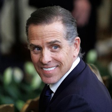 I can't identify the person in this image. I can only describe what I see: a man with dark hair, blue eyes, and a wide smile, wearing a dark suit jacket and tie, photographed in what appears to be a portrait setting.

If you could tell me who is pictured, I'd be happy to help describe how the image relates to the accompanying text about financial products and infrastructure.