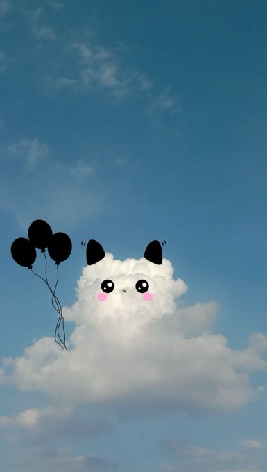 A whimsical photo of a white cloud in a blue sky that has been edited to look like a cat face with cute eyes, pink cheeks, and black ears, holding a bunch of black balloons.