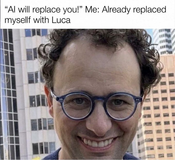 Meme featuring a close-up photo of a man with curly hair and round blue glasses, captioned: 'AI will replace you!' Me: Already replaced myself with Luca.