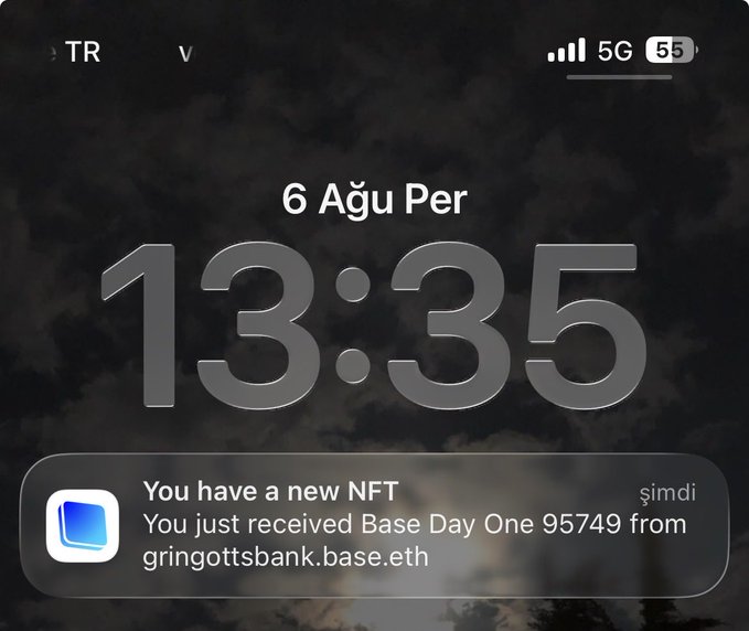 A phone lock screen displays the time 13:35 on Friday, August 6, with a notification reading "You have a new NFT — You just received Base Day One 95749 from gringottsbank.base.eth." The notification about receiving a Base NFT on the day it launched ("Day One") visually reinforces the post's reflection that this may be the day being referenced.